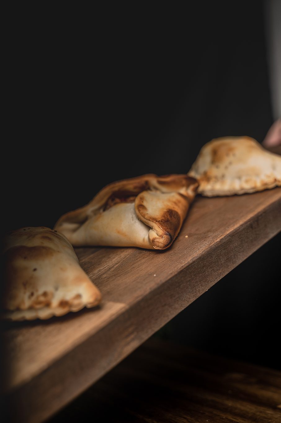 Fresh empanadas on wooden board
