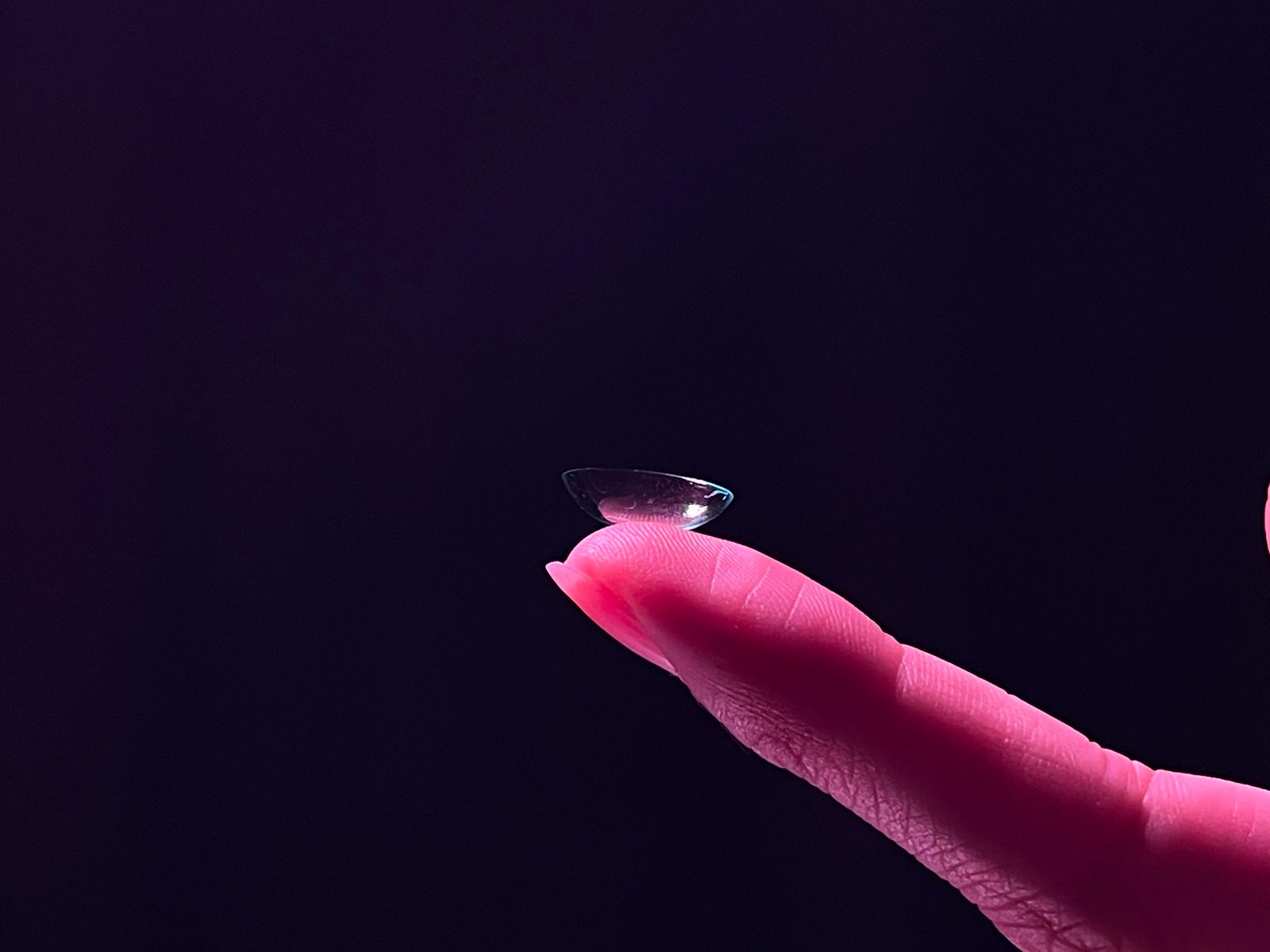 EDEN lens on finger with warm backlight